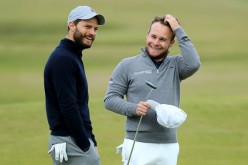 Tyrrell Hatton of England with his playing partner actor Jamie Dornan on the 12th green during the final round of the Alfred Dunhill Links Championship at The Old Course on October 9, 2016 in St Andrews, Scotland.