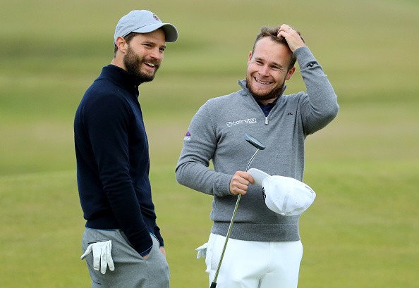 Tyrrell Hatton of England with his playing partner actor Jamie Dornan on the 12th green during the final round of the Alfred Dunhill Links Championship at The Old Course on October 9, 2016 in St Andrews, Scotland.