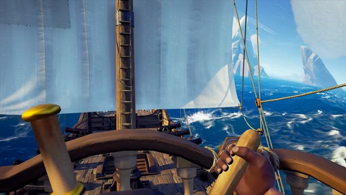The helmsman steering a pirate ship in 'Sea of Thieves.'