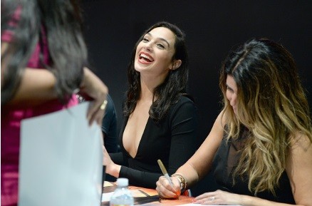 Actress Gal Gadot from the 2017 feature film Wonder Woman signs autographs for fans in DC's 2016 San Diego Comic-Con booth at San Diego Convention Center on July 23, 2016 in San Diego, California.