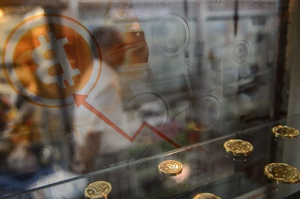 A man walks past a bitcoin exchange facility in Hong Kong.