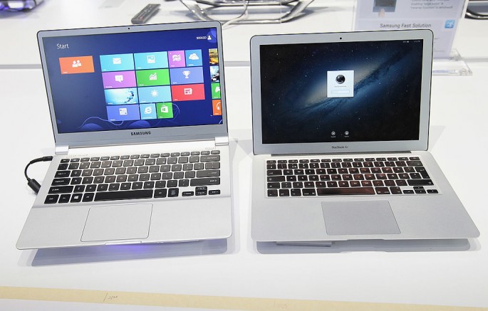 An ultra thin Samsung Notebook Series 9 laptop computer runnung Microsoft Windows 8 sits next to an Apple Macbook Air brought by a visitor during a press day at the Samsung stand at the IFA 2012 consumer electronics trade fair on August 30, 2012 in Berlin