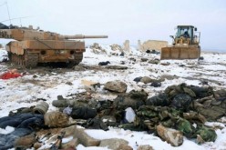 After the Turkish Army defeat at al-Bab, a knocked-out Leopard 2A4; an armored bulldozer and army equipment litter the ground.          