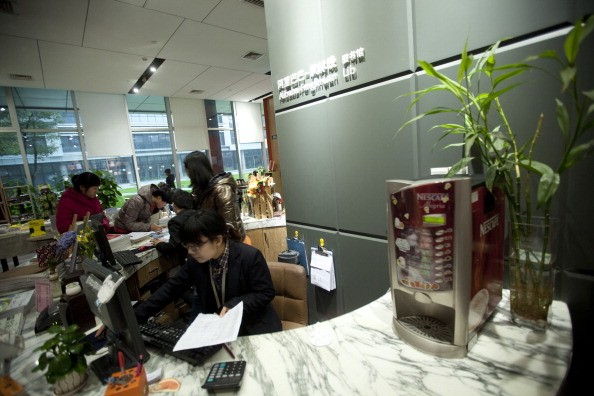 Workers browse books in the library and bookstore at Alibaba.com Ltd.'s headquarters in Hangzhou, Zhejiang Province.