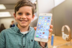 Levi aged 10, shows of the new iPhone 6s Plus in rose gold as crowds wait in anticipation for the release of the iPhone 6s and 6s Plus.