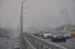 Vehicles run in the smog on March 17, 2016 in Beijing, China.