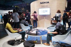 Attendees wear Samsung Gear VR virtual reality headsets to demonstrate the Ozo, a virtual reality camera, manufactured by Nokia Oyj, on the Nokia booth during the Slush startups event in Helsinki, Finland, on Wednesday, Nov. 30, 2016.