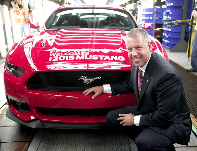 Joe Hinrichs, Ford President of the Americas, poses with the first production 2015 Ford Mustang before driving it off the assembly line at the Ford Flat Rock Assembly Plant August 28, 2014 in Flat Rock, Michigan.