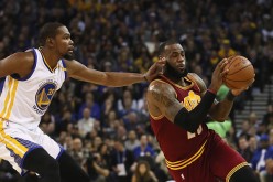 LeBron James of the Cleveland Cavaliers is guarded by Kevin Durant of the Golden State Warriors at ORACLE Arena on January 16, 2017 in Oakland, California.