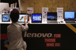 A woman doing hand-on on a Lenovo laptop.
