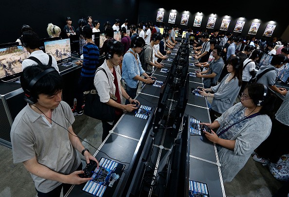 Visitors play the Final Fantasy XV video game on Sony Interactive Entertainment Inc.'s PlayStation 4 game consoles in the Square Enix Co. booth at Tokyo Game Show on September 17, 2016 in Chiba, Japan. 