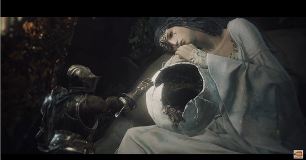 A 'Dark Souls III' character tries to touch the crumbling sphere sitting on the woman's lap.