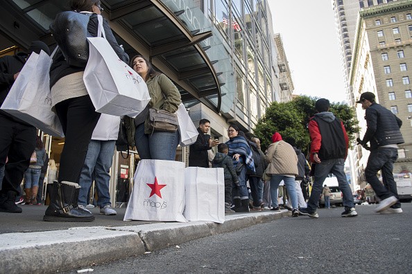 Shoppers stand outside Macy's, a U.S. mega-retailer that opened an online shop on Alibaba.com.