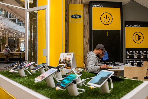 Mobile handsets and smartphones sit on display inside an MTN Group Ltd. telecommunications store in Hyde Park District of Johannesburg, South Africa.