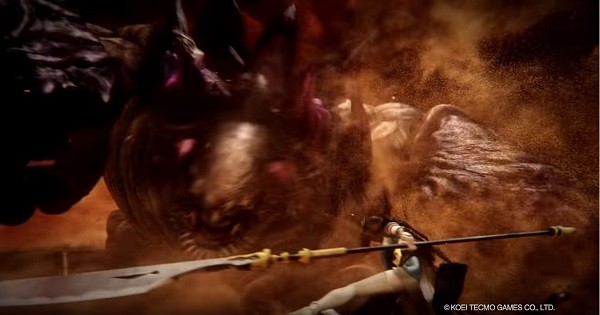 A "Toukiden 2" character prepares her spear before receiving an immense attack against an Oni.
