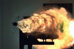 A U.S. Navy electromagnetic railgun propels a test round towards a target.            