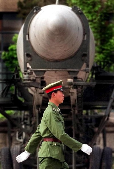 A Chinese People's Liberation Army (PLA) soldier walks past a medium-range ballistic missile on display at Beijing's Military Museum.