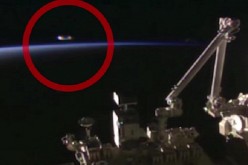 An image of a UFO captured by International Space Station cameras shows a bright object above the earth's horizon.