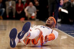 Carmelo Anthony of the New York Knicks falls as he follows through on a shot in the fourth quarter against the Charlotte Hornets at Madison Square Garden on January 27, 2017 in New York City. 
