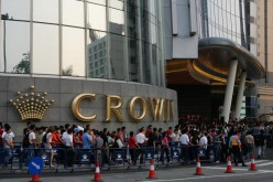 Visitors wait for the casino hotel Crown Macau official opening May 12, 2007 in Macau, China. 