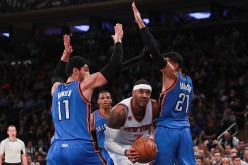  Carmelo Anthony of the New York Knicks fights for position with Enes Kanter and Andre Roberson of the Oklahoma City Thunder during the second half at Madison Square Garden on November 28, 2016 in New York City. 