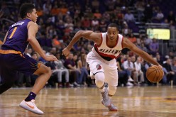 C.J. McCollum of the Portland Trail Blazers drives the ball past Devin Booker of the Phoenix Suns during the first half of the NBA game at Talking Stick Resort Arena on November 2, 2016 in Phoenix, Arizona. 