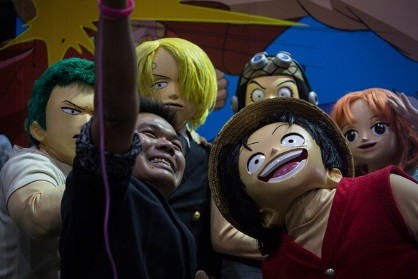 Visitor takes a selfie with cosplayers dressed as 'One Piece' characters during the Bangkok Comic Con 2016 Festival at Bitec Exhibition Centre in Bangkok, Thailand on April 29, 2016.