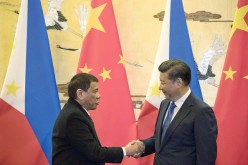 Chinese President Xi Jinping (R) shakes hands with Philippine President Rodrigo Duterte during a signing ceremony at the Great Hall of the People in Beijing last year. 