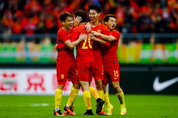 Chinese players celebrate after winning the game.