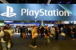 Gamers visit the PlayStation booth during a video game conference.