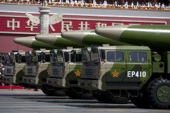 Military vehicles carrying DF-26 ballistic missiles drive past the Tiananmen Gate during a military parade on Sept. 3, 2015 in Beijing, China.
