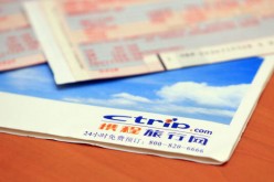 Airplane tickets and a Ctrip.com envelope on a table in Beijing, China.