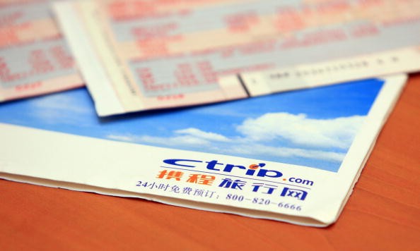 Airplane tickets and a Ctrip.com envelope on a table in Beijing, China.
