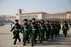 Chinese paramilitary police officers patrol Tiananmen Square.