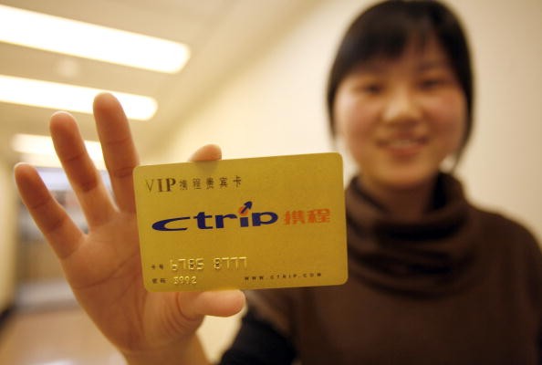 A woman displays a Ctrip.com International Ltd. membership card in Shanghai, China.