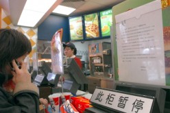 A consumer buys food at a Kentucky Fried Chicken outlet in Beijing, China.