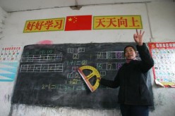 A teacher gestures as she gives a class at Xinxing School, a primary school for migrant children, Dec. 30, 2004, in Beijing, China. 