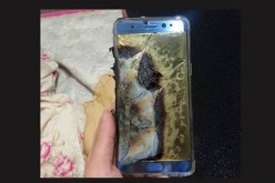 A Note 7 is held by hand to show the aftermath of the smartphone explosion. 