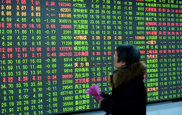 An investor watches the electronic board at a stock exchange hall on Feb. 3, 2017 in Hangzhou, Zhejiang Province. 
