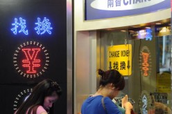 People line up at a currency changer in Hong Kong. 
