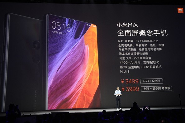 Lei Jun, Chairman and Chief Executive Officer of Xiaomi Inc., introduces Xiaomi VR glasses and new smartphones during a launch event at Peking University Gymnasium.
