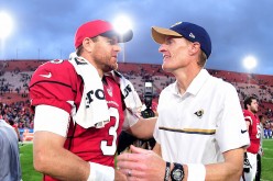 Head coach John Fassel of the Los Angeles Rams shakes hands with Carson Palmer of the Arizona Cardinals after a 44-6 Cardinals win at Los Angeles Memorial Coliseum.