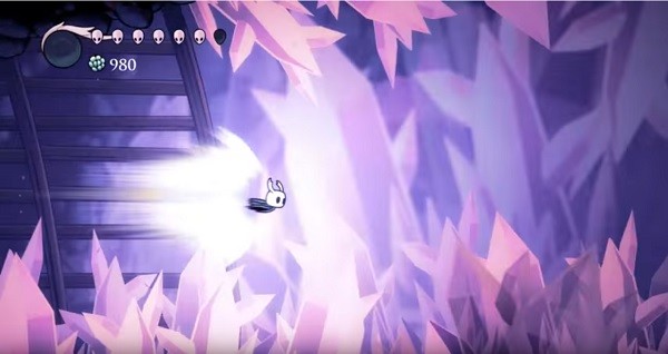 The "Hollow Knight" main protagonist uses his air dash ability to go through the cave with sharp crystals.