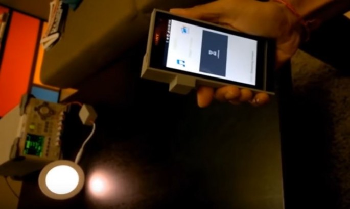 A smartphone is being used to display the potentials of Li-Fi with the help of a LED bulb. 