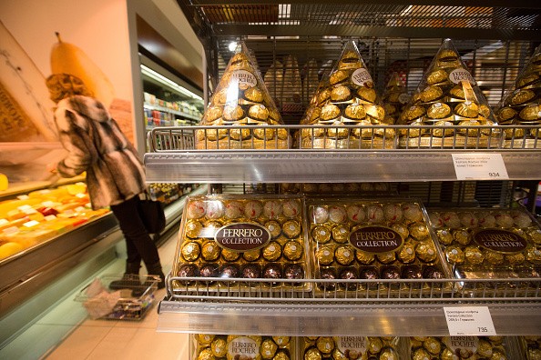 A customer shops near a display of Ferrero Rocher chocolates inside a supermarket.