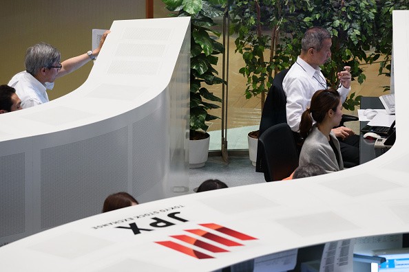 Employees working at the Tokyo Stock Exchange 