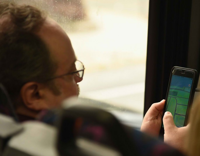  A man plays Pokemon Go while on the bus on August 10, 2016 in New York City.
