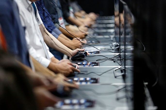 Visitors play a video game on Sony Interactive Entertainment Inc. PlayStation 4 game consoles in the Square Enix Co. booth at the Tokyo Game Show 2016.