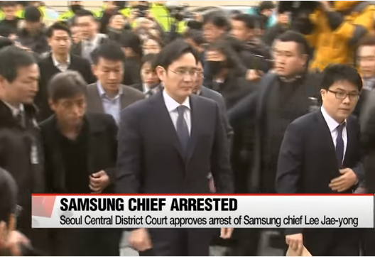 Samsung's Lee Jae-yong as he is being accompanied by his security details. 