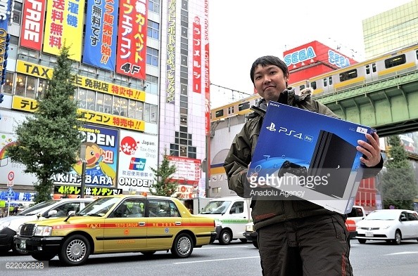 A customer holds PlayStation 4 Pro